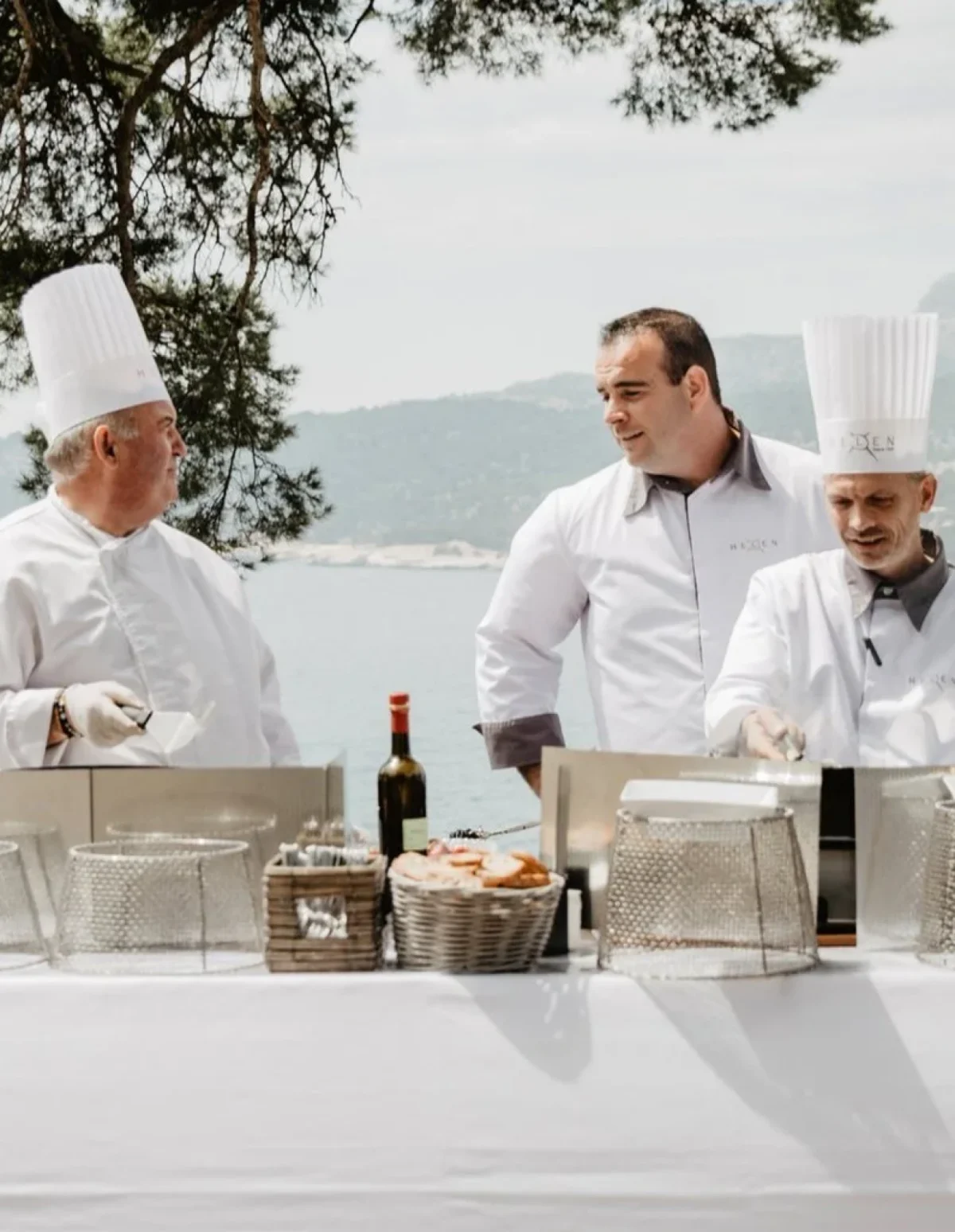 Private chefs plating at an outdoor coastal buffet